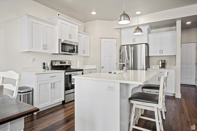 4488 S Haven Creek Rd W Unit 25D, West Haven, UT 84401 - kitchen with appliances with stainless steel finishes, dark wood-style flooring, light countertops, white cabinets, and recessed lighting
