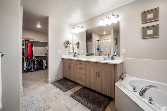 4488 S Haven Creek Rd W Unit 25D, West Haven, UT 84401 - bathroom featuring a stall shower, double vanity, a bath, tile patterned floors, and a spacious closet