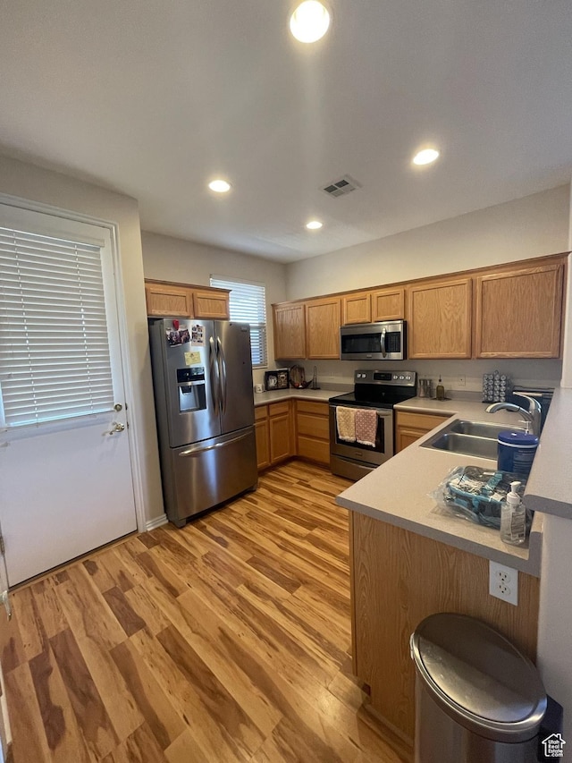 3400 E Hidden Springs Dr, Washington, UT 84780 - kitchen featuring stainless steel appliances, a sink, light countertops, light wood-style floors, and recessed lighting