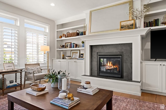 12387 Timberline Dr Unit 53, Highland, UT 84003 - living room featuring light wood finished floors, a glass covered fireplace, recessed lighting, and built in shelves