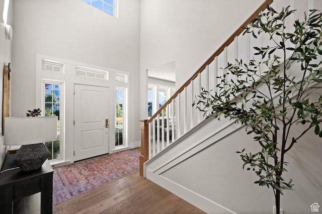 12387 Timberline Dr Unit 53, Highland, UT 84003 - foyer with wood finished floors, a towering ceiling, stairway, and plenty of natural light