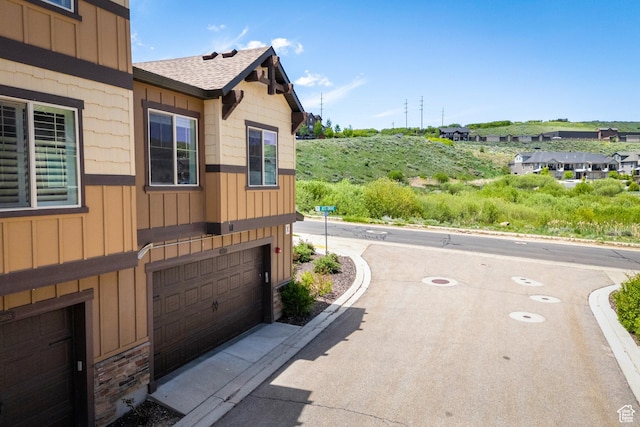 13609 N Hill Climb Ln, Kamas, UT 84036 - view of side of home featuring a shingled roof, a garage, and board and batten siding