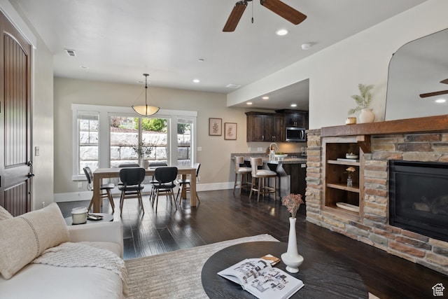 13609 N Hill Climb Ln, Kamas, UT 84036 - living room featuring a ceiling fan, dark wood-type flooring, baseboards, recessed lighting, and a fireplace