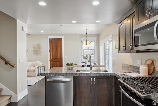 13609 N Hill Climb Ln, Kamas, UT 84036 - kitchen with appliances with stainless steel finishes, a sink, dark brown cabinetry, light stone countertops, and recessed lighting