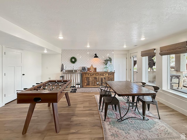 1852 N 4100 W, Plain City, UT 84404 - rec room featuring a textured ceiling, light wood finished floors, recessed lighting, and a sink