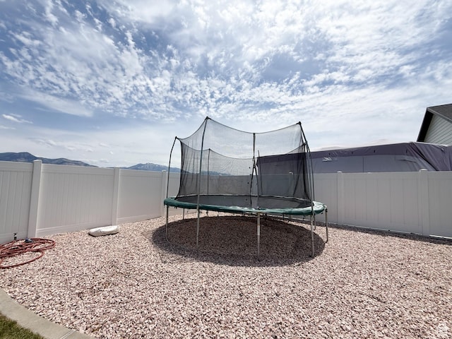1852 N 4100 W, Plain City, UT 84404 - fenced backyard with a trampoline and a mountain view