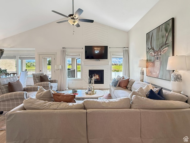 1852 N 4100 W, Plain City, UT 84404 - living area featuring high vaulted ceiling, a premium fireplace, plenty of natural light, a ceiling fan, and wood finished floors