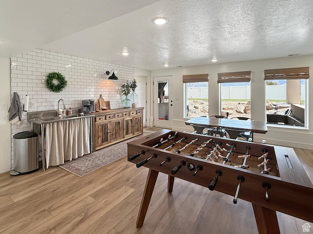 1852 N 4100 W, Plain City, UT 84404 - game room featuring light wood-style floors, plenty of natural light, a textured ceiling, and recessed lighting