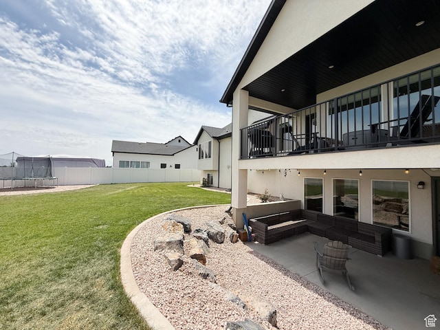 1852 N 4100 W, Plain City, UT 84404 - view of yard featuring a trampoline, a patio area, and a balcony
