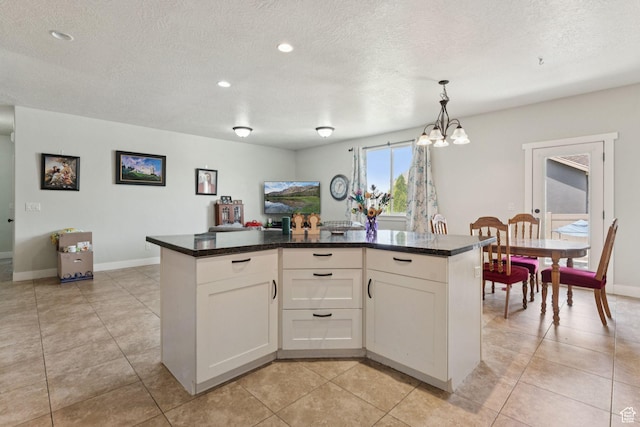 301 E Salem Park Cir, Salem, UT 84653 - kitchen with a chandelier, white cabinetry, baseboards, dark countertops, and a textured ceiling