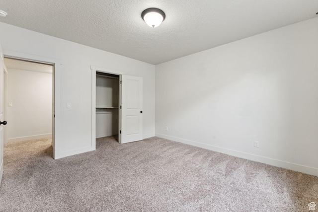 301 E Salem Park Cir, Salem, UT 84653 - unfurnished bedroom featuring carpet floors, baseboards, a textured ceiling, and a closet