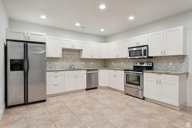 301 E Salem Park Cir, Salem, UT 84653 - kitchen with appliances with stainless steel finishes, a sink, backsplash, white cabinetry, and recessed lighting