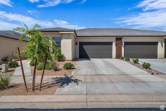 1210 W Ledgerwood Dr, St George, UT 84790 - view of front of property with a tiled roof, a garage, driveway, and stucco siding