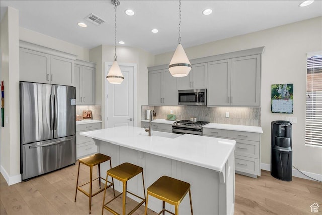 1210 W Ledgerwood Dr, St George, UT 84790 - kitchen with stainless steel appliances, light wood-style floors, light countertops, decorative backsplash, and recessed lighting