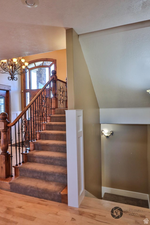 692 E 5020 N, Enoch, UT 84721 - stairway featuring a chandelier, wood finished floors, vaulted ceiling, baseboards, and a textured ceiling