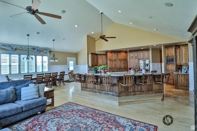692 E 5020 N, Enoch, UT 84721 - living room featuring a ceiling fan, high vaulted ceiling, light wood-style floors, a chandelier, and recessed lighting