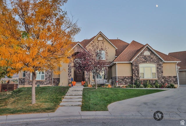 692 E 5020 N, Enoch, UT 84721 - view of front of property featuring stucco siding, stone siding, a front lawn, and a tile roof