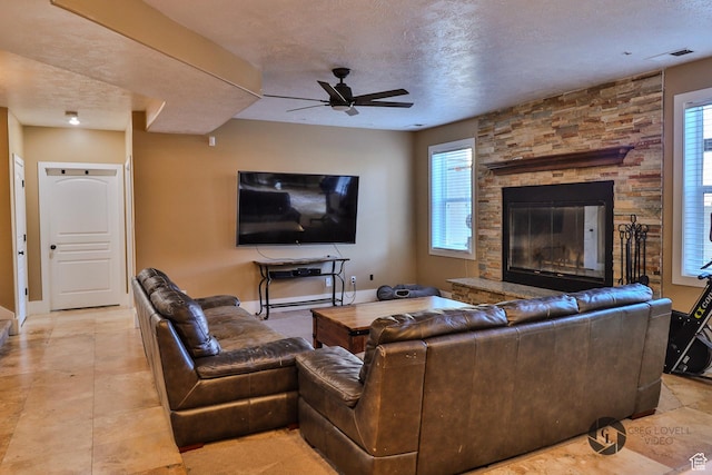692 E 5020 N, Enoch, UT 84721 - living area featuring ceiling fan, a textured ceiling, a fireplace, and baseboards