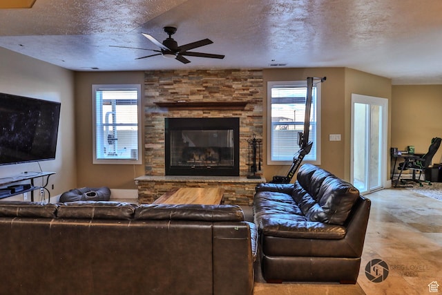 692 E 5020 N, Enoch, UT 84721 - living area with healthy amount of natural light, ceiling fan, a textured ceiling, and a stone fireplace