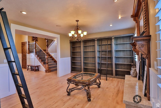 692 E 5020 N, Enoch, UT 84721 - sitting room with stairs, wood finished floors, wainscoting, a chandelier, and recessed lighting