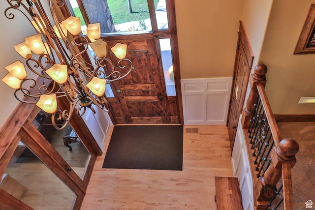 692 E 5020 N, Enoch, UT 84721 - entryway featuring wood finished floors, a wainscoted wall, and a decorative wall