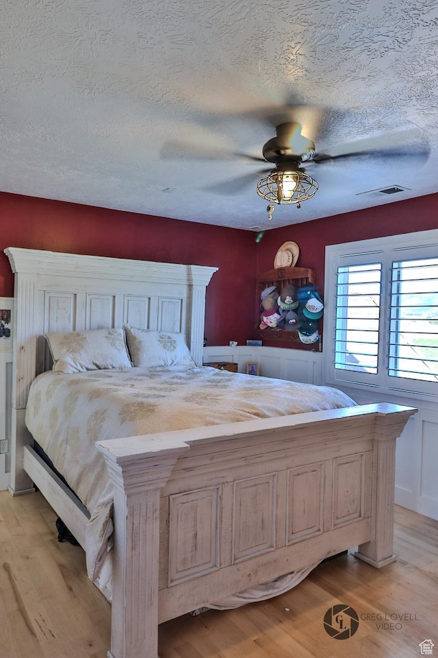 692 E 5020 N, Enoch, UT 84721 - bedroom with light wood-style flooring, a textured ceiling, and ceiling fan