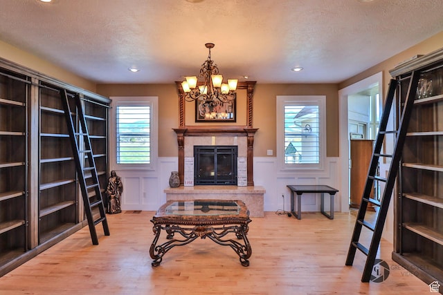 692 E 5020 N, Enoch, UT 84721 - living room with light wood-style flooring, a wainscoted wall, a textured ceiling, a chandelier, and recessed lighting