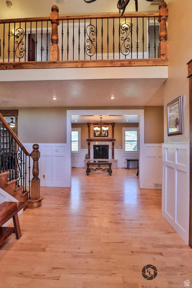 692 E 5020 N, Enoch, UT 84721 - living room featuring a decorative wall, stairway, light wood-type flooring, healthy amount of natural light, and wainscoting