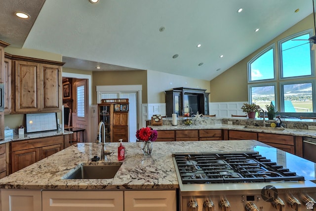 692 E 5020 N, Enoch, UT 84721 - kitchen with a sink, gas cooktop, brown cabinets, recessed lighting, and high vaulted ceiling