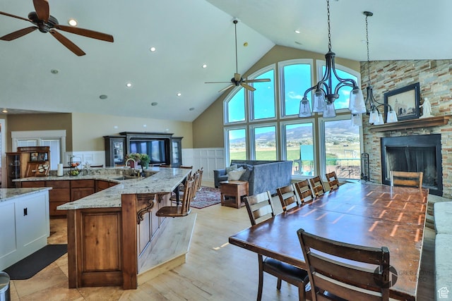 692 E 5020 N, Enoch, UT 84721 - kitchen with a ceiling fan, high vaulted ceiling, a sink, open floor plan, and light stone counters