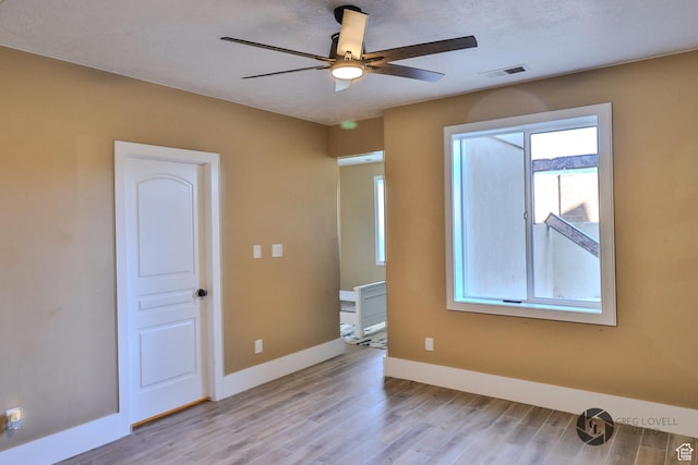 692 E 5020 N, Enoch, UT 84721 - unfurnished room featuring a ceiling fan, light wood-style floors, and baseboards