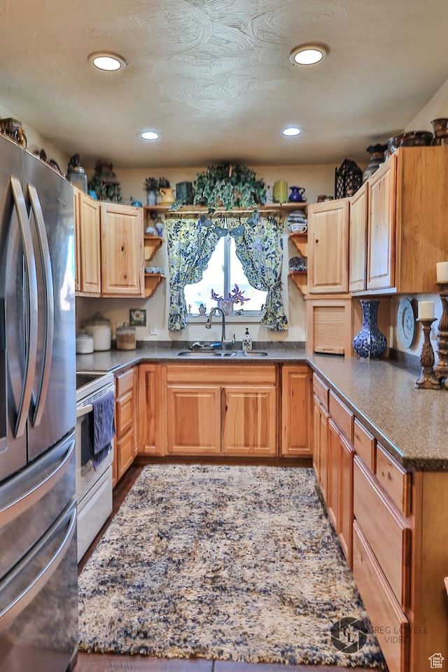 692 E 5020 N, Enoch, UT 84721 - kitchen with stainless steel appliances, a sink, open shelves, recessed lighting, and dark stone counters