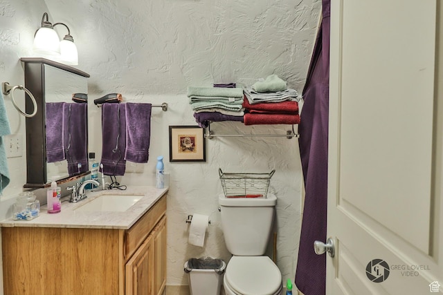 692 E 5020 N, Enoch, UT 84721 - bathroom featuring vanity, toilet, and a textured wall