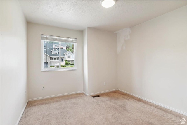 497 E 3525 N, North Ogden, UT 84414 - spare room featuring light colored carpet, a textured ceiling, and baseboards