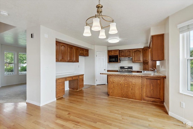 497 E 3525 N, North Ogden, UT 84414 - kitchen featuring stainless steel range with electric stovetop, black microwave, light wood-type flooring, and brown cabinetry