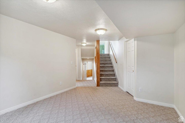 497 E 3525 N, North Ogden, UT 84414 - below grade area with carpet, a textured ceiling, stairway, and baseboards