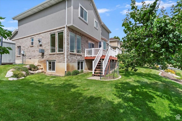 497 E 3525 N, North Ogden, UT 84414 - back of property with stairway, a wooden deck, a yard, brick siding, and stucco siding