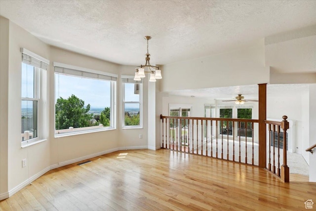 497 E 3525 N, North Ogden, UT 84414 - unfurnished room with wood-type flooring, a chandelier, a textured ceiling, baseboards, and ceiling fan
