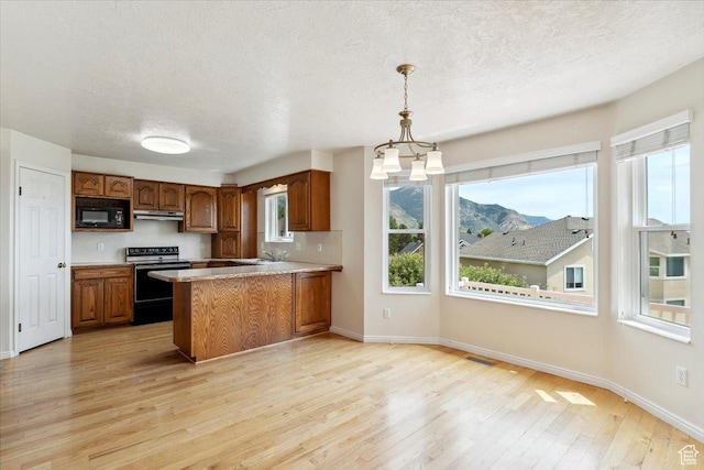 497 E 3525 N, North Ogden, UT 84414 - kitchen featuring electric stove, black microwave, under cabinet range hood, light wood-type flooring, and brown cabinets
