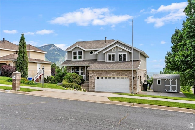 497 E 3525 N, North Ogden, UT 84414 - traditional home featuring an attached garage, a shingled roof, concrete driveway, a mountain view, and stucco siding