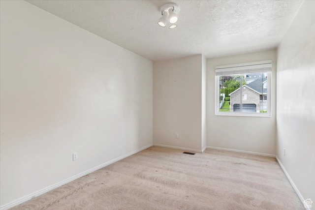 497 E 3525 N, North Ogden, UT 84414 - unfurnished room with light colored carpet, a textured ceiling, and baseboards