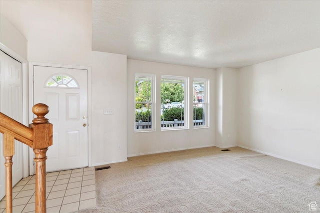 497 E 3525 N, North Ogden, UT 84414 - entryway with light carpet, baseboards, and a textured ceiling