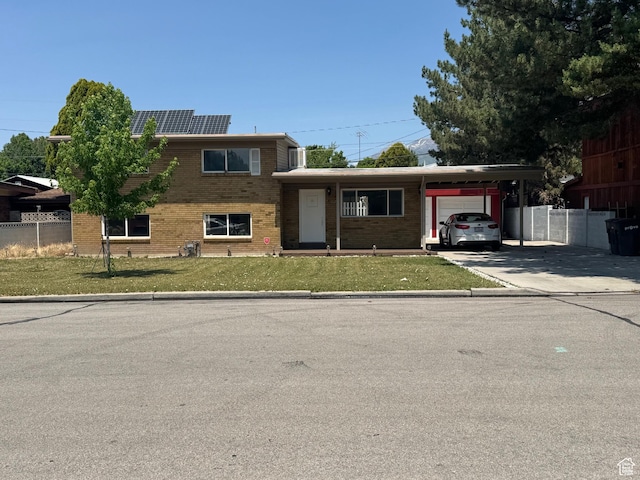 1102 W 860 N, Provo, UT 84604 - view of front facade featuring a garage, brick siding, driveway, and roof mounted solar panels