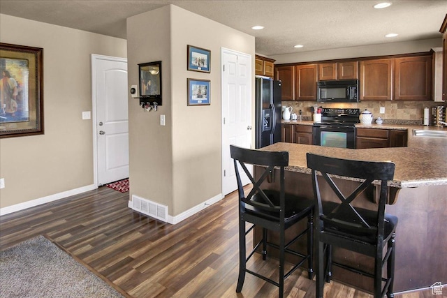2118 W Foxwood St, West Haven, UT 84401 - kitchen featuring black appliances, dark wood-type flooring, baseboards, and recessed lighting