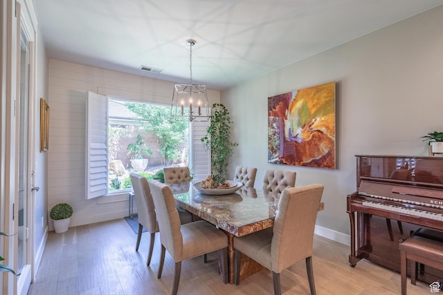2573 S 3160 E, St George, UT 84790 - dining area with light wood finished floors, a chandelier, and baseboards