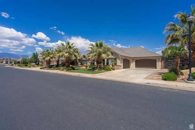 2573 S 3160 E, St George, UT 84790 - view of front facade with a garage, driveway, stucco siding, and a residential view