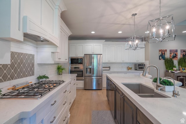 2573 S 3160 E, St George, UT 84790 - kitchen with appliances with stainless steel finishes, a sink, recessed lighting, a chandelier, and white cabinets