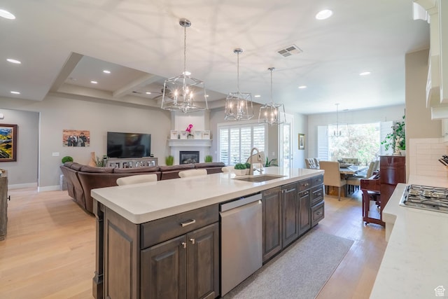 2573 S 3160 E, St George, UT 84790 - kitchen with appliances with stainless steel finishes, a chandelier, light countertops, a sink, and plenty of natural light