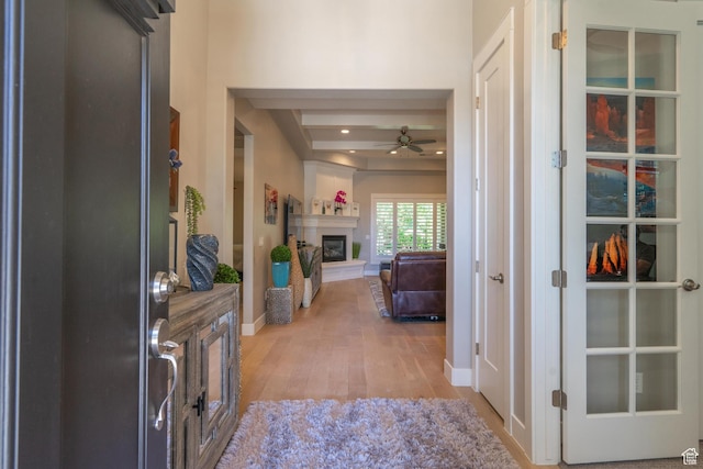2573 S 3160 E, St George, UT 84790 - entrance foyer featuring light wood-style floors, ceiling fan, a glass covered fireplace, and baseboards
