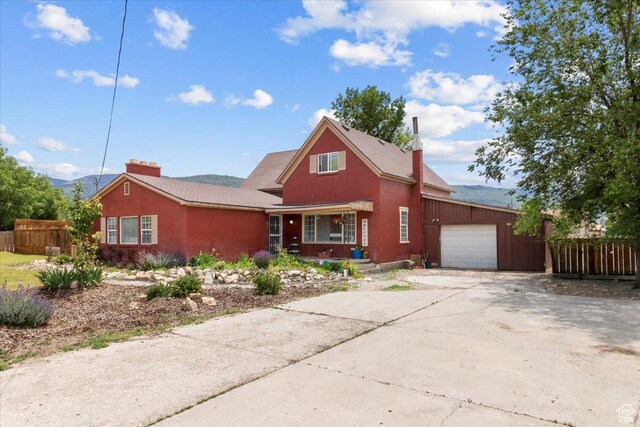 125 W 300 S, Ephraim, UT 84627 - view of front of home featuring covered porch, an attached garage, driveway, and a chimney